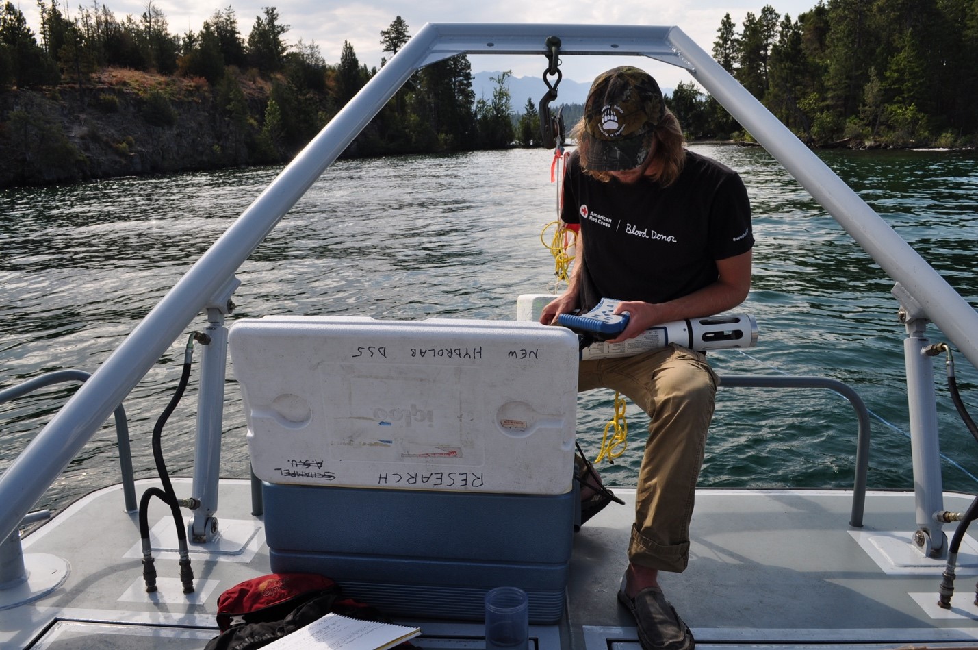 Collecting water samples by boat in Yellow Bay