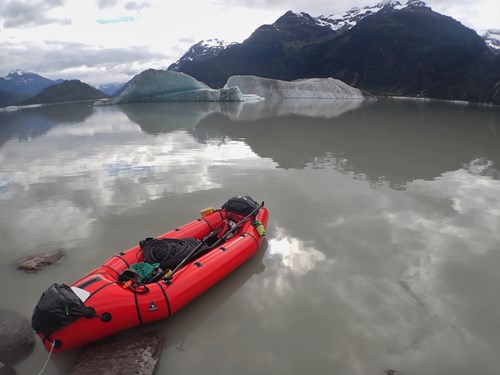 Research Kayak on a calm body of water with mountains in the background
