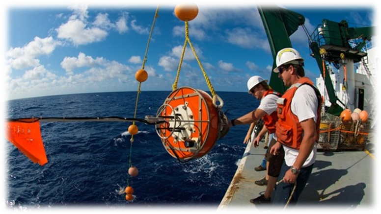 Members of the science team retrieve an ocean buoy