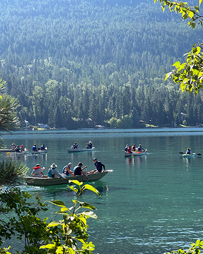 A group paddles FLBS canoes into Yellow Bay