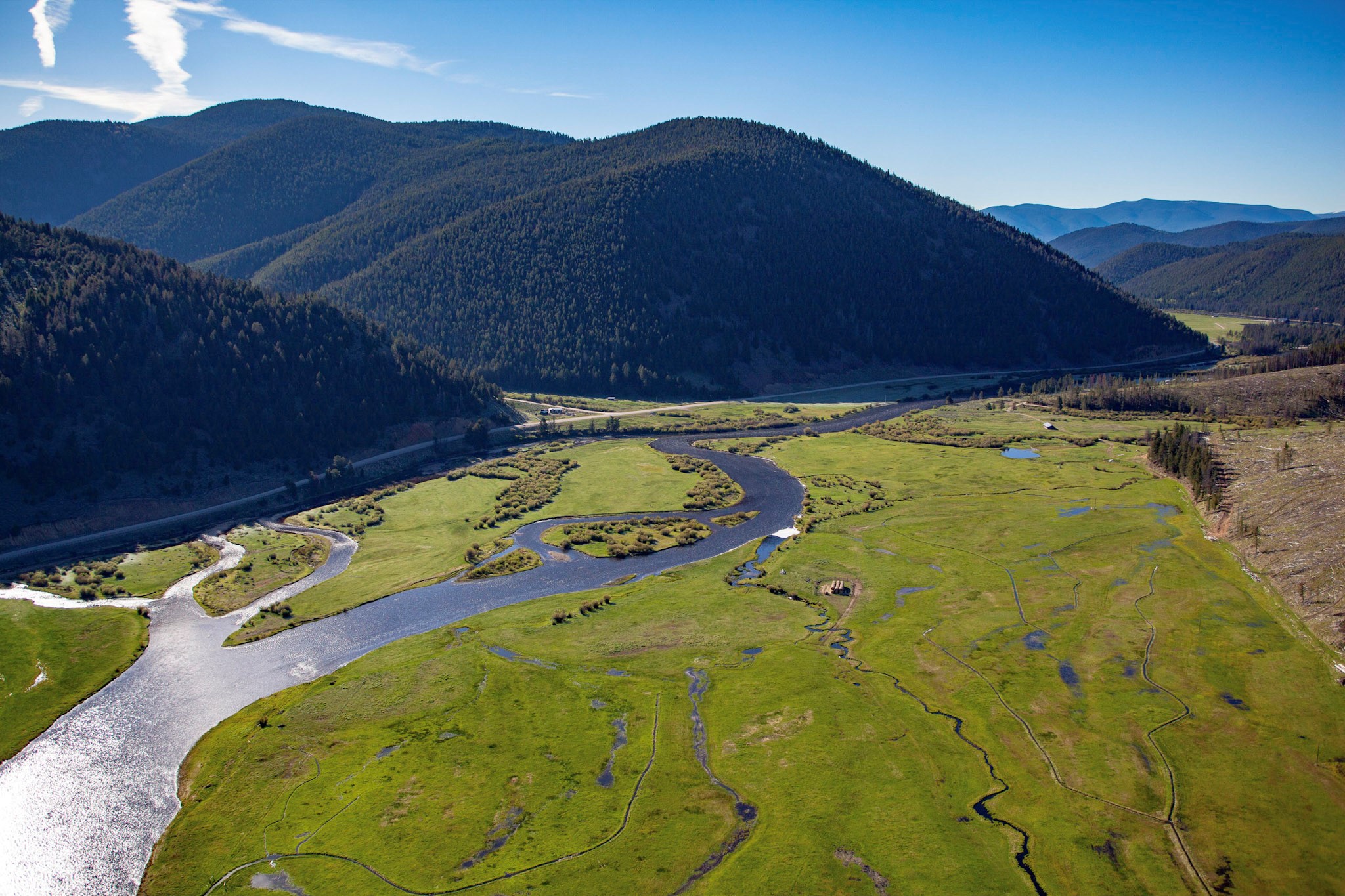 East Bank of a watershed containing mountains, a valley, and a meandering river in the valley.