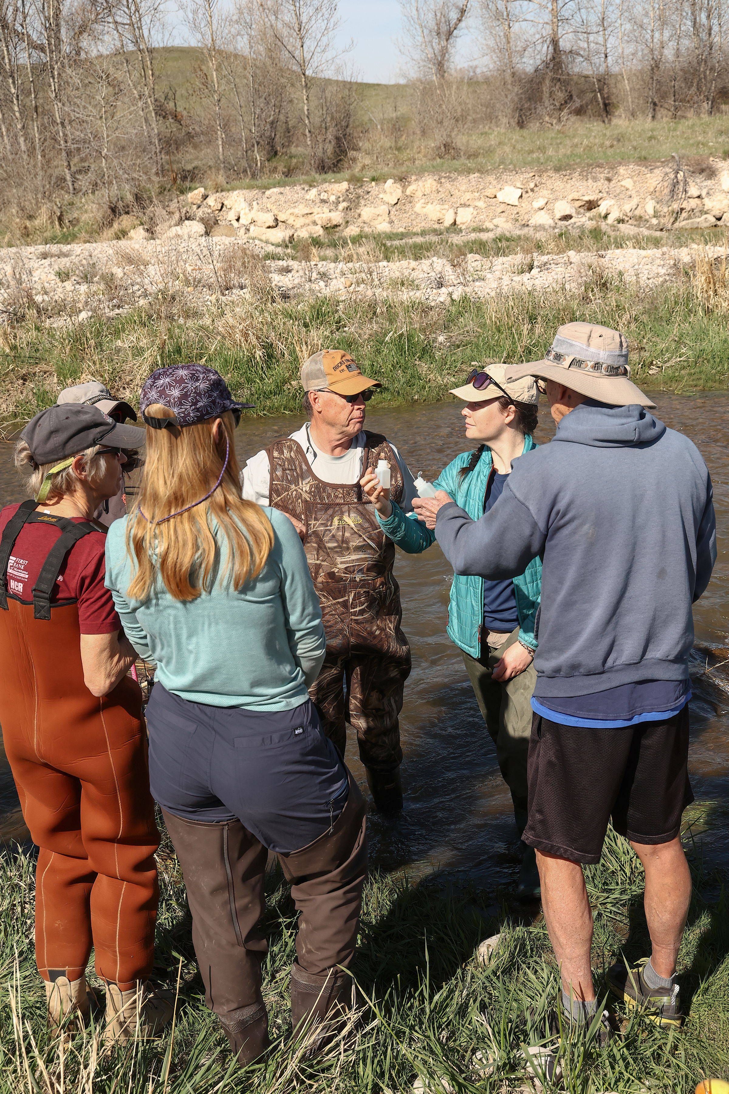 Volunteers learning how to collect water monitoring samples for MMW are being trained by Callie Nelson.