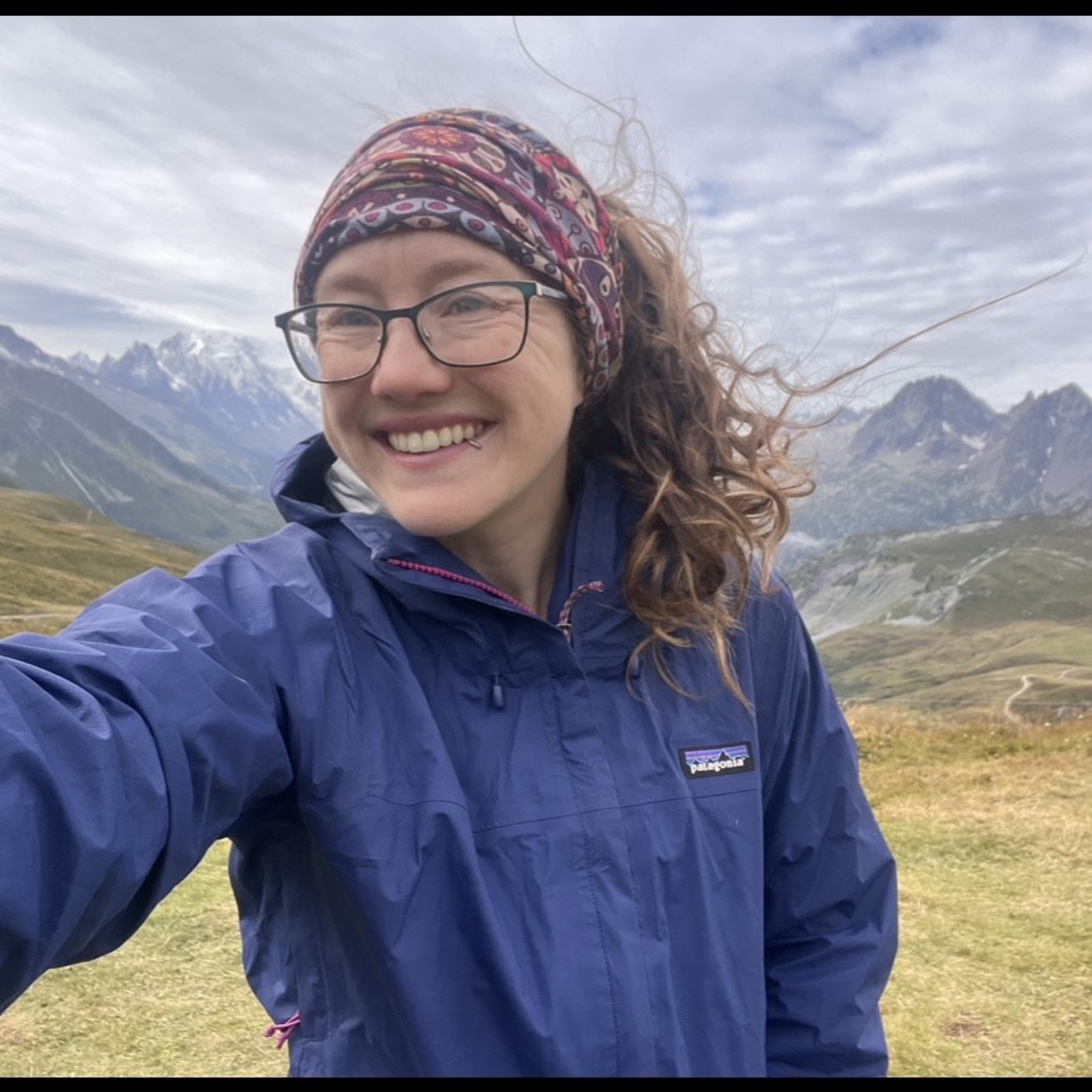 Danie Frevola standing in front of the Swiss Alps