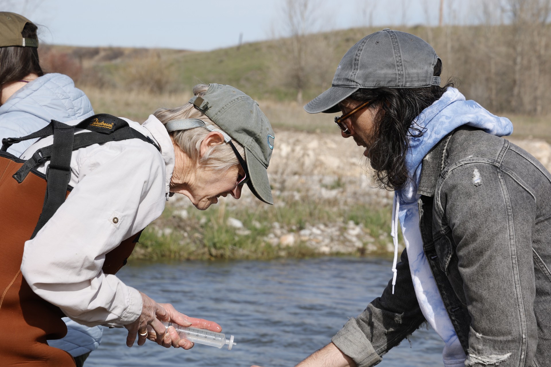 Two Central Montana Resource Council members collecting a filtered sample.