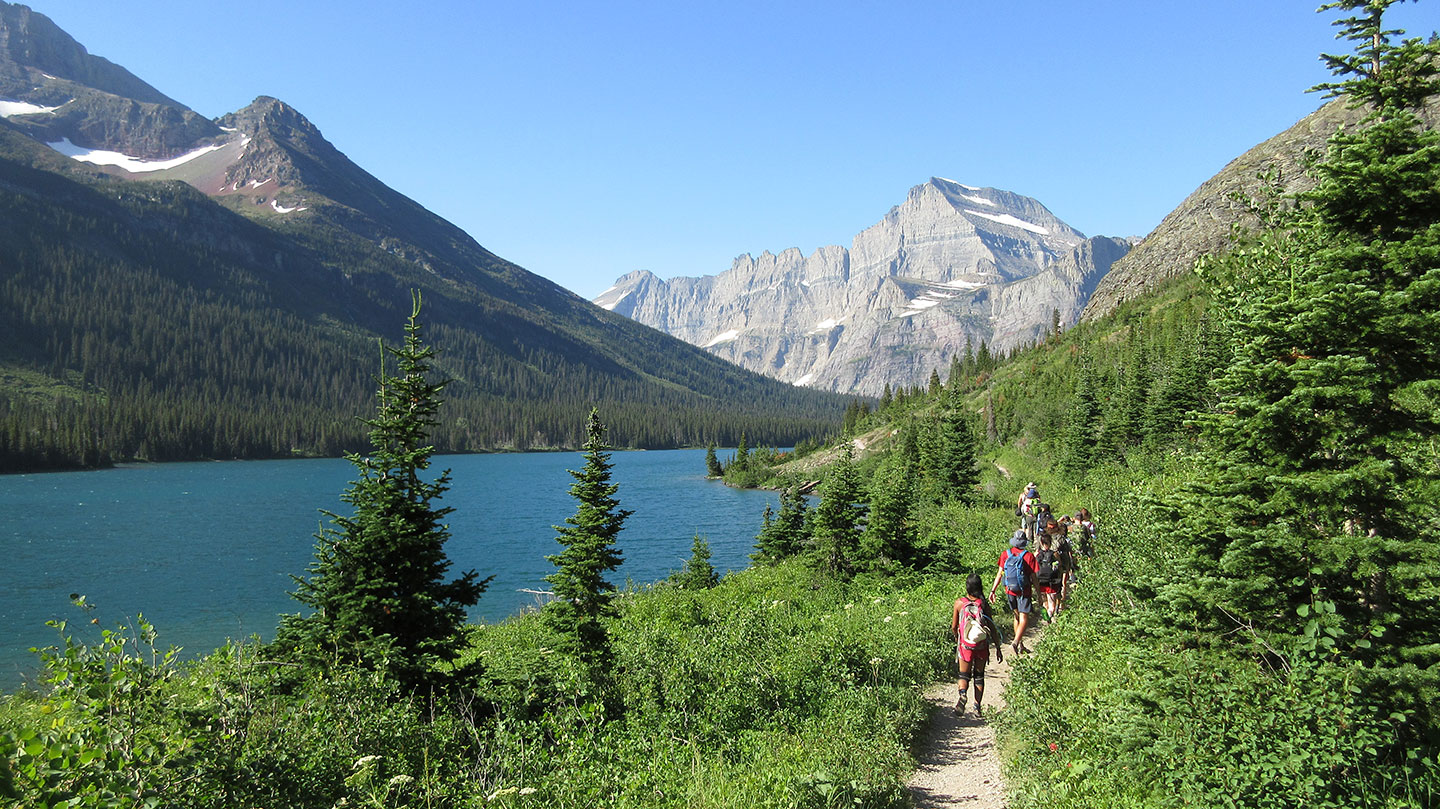 Students hike a trail along the shore of St. Mary Lake, Glacier National Park