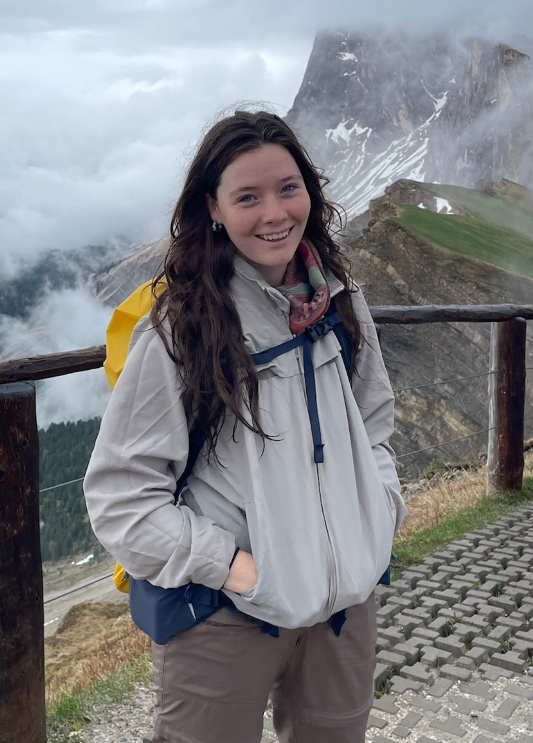 Callie Nelson smiling and standing in front of a mountain.