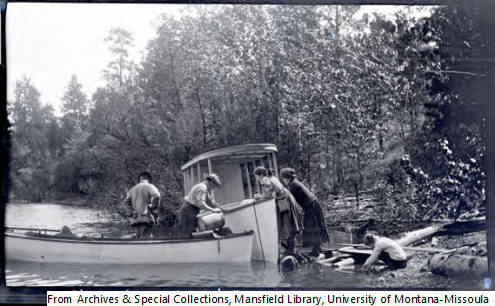 Early 1900s students gather gear into boats for lake sampling