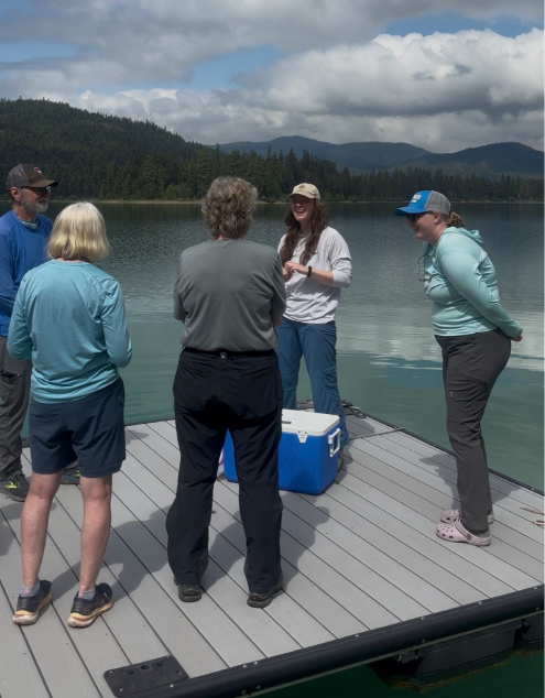 Callie Nelson and Abbie Ebert instructing volunteers on collecting water samples.