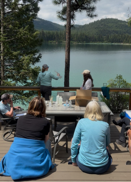 Abbie Ebert instructing Thompson Chain of Lakes Stewardship Coalition volunteers on how to collect a chlorophyll a sample.