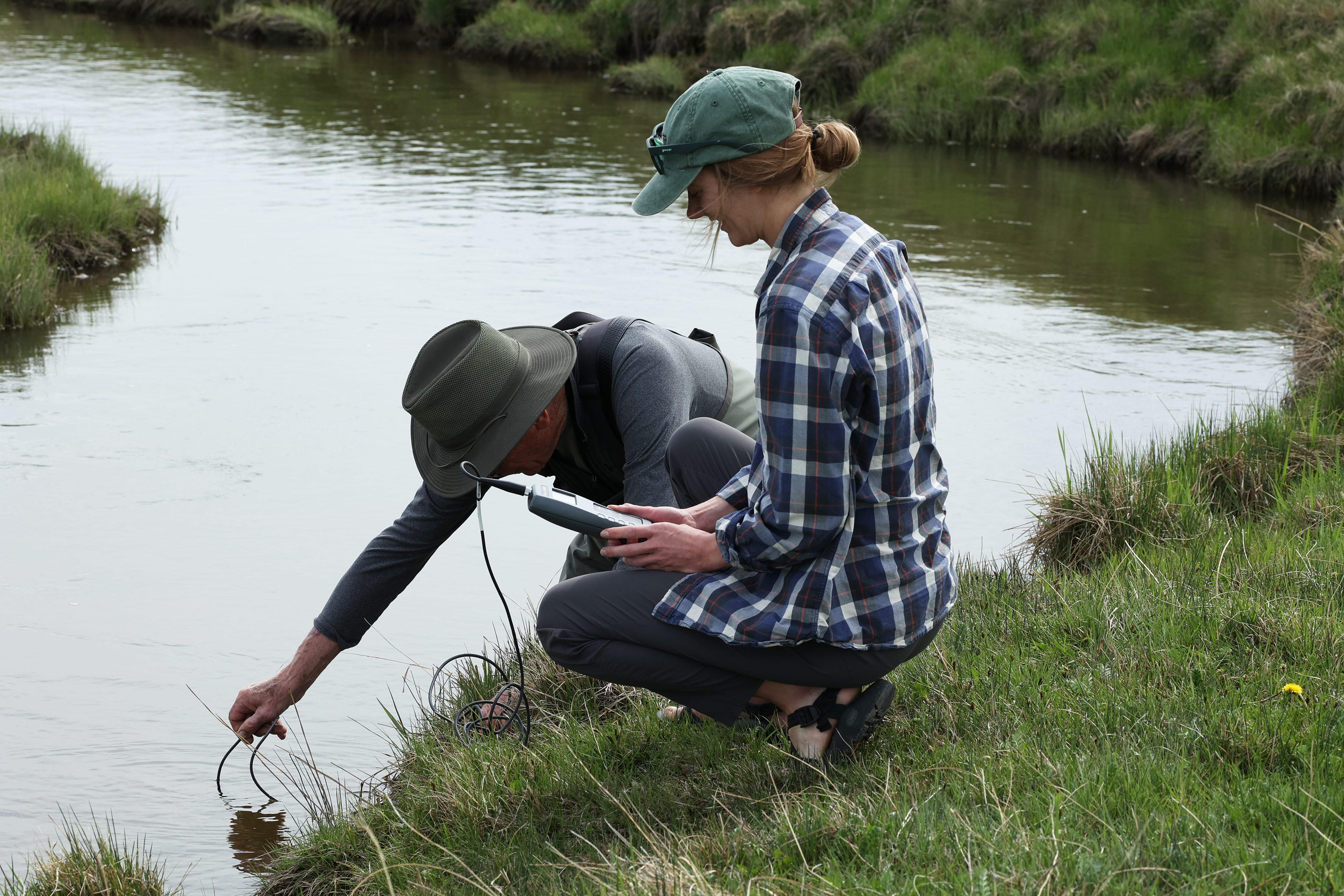 A Big Sky Watershed Corp member and a Central Montana Resource Council member collecting data using a YSI instrument.