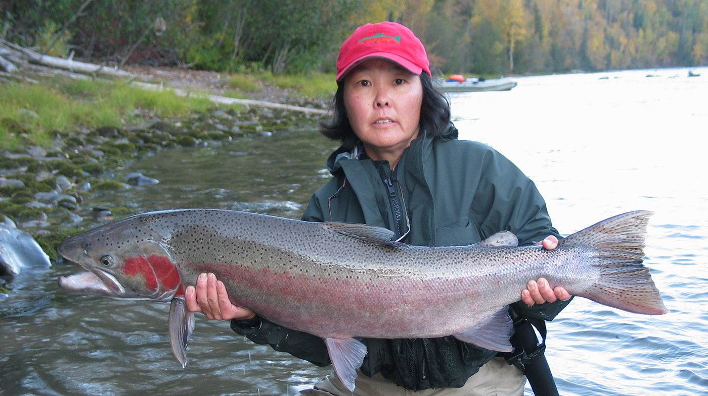 Shauna holding a salmon during SaRON fieldwork.