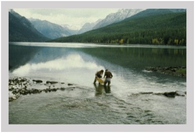 Jack Stanford and Ric Hauer examine a kicknet at the outlet of MacDonald Lake, Glacier National Park