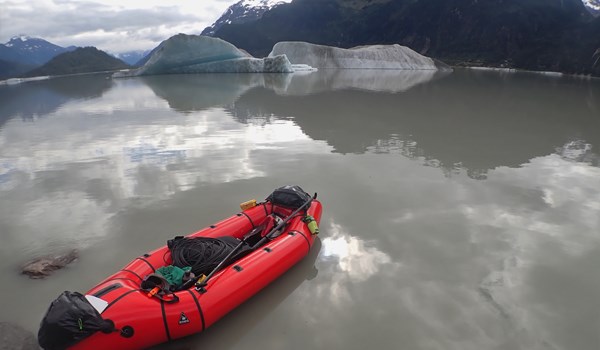 Inflatable kayak with research equipment on waterbody in Alaska