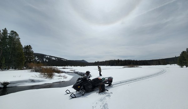 Big Hole River Foundation using snow mobiles to access the headwater sampling site in early April