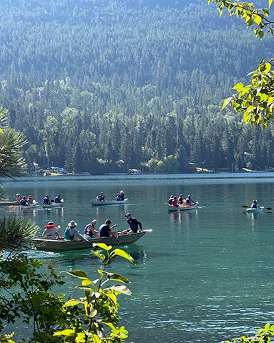 Students sample the waters from canoes in Yellow Bay on Flathead Lake